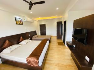 a bedroom with a bed and a flat screen tv at Shivanand Residency in Jejūri