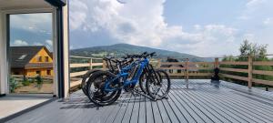 a blue bike parked on a wooden deck at Level780 in Koszarawa