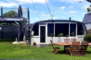 a circular house with a table and chairs in a yard at Chill at our Igloo cottage - 100m stroll to beach in Portarlington