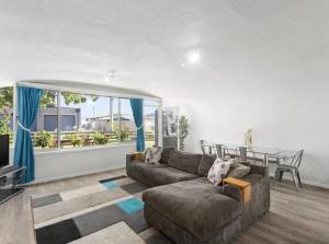 a living room with a couch and a table at Chill at our Igloo cottage - 100m stroll to beach in Portarlington