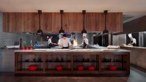 a group of chefs in a kitchen preparing food at Las Terrazas de Abama Suites in Guía de Isora