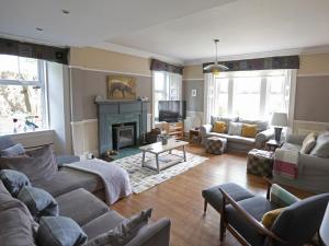 a living room with couches and a fireplace at Roseburn in Pitlochry