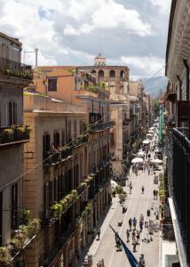 a city street with buildings and people walking on the street at Villena Plaza in Palermo