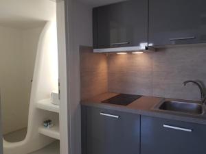 a kitchen with a sink and a counter top at Empyreal Blue Apartments in Dexamenes +33 photos