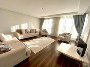 a living room with two couches and a tv at Wonderful Villa Airport 5 minutes in Arnavutköy
