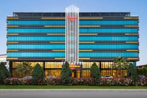 a tall building with a flag on top of it at Ramada Plaza by Wyndham Samsun in Samsun