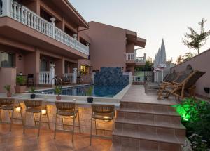 a house with a swimming pool in a yard at Kseynasa Suites in Nikiti