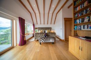 a zebra chair in a room with a large window at Knockderry Lodge -Private Luxury pet-friendly accommodation in Scotland with hot tub in Cove