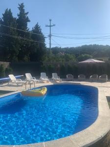 a swimming pool with a raft in the middle at Mika’s Poolhouse in Belgrade