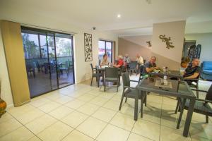 a group of people sitting at tables in a restaurant at Spinifex Motel and Serviced Apartments in Mount Isa