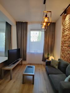 a living room with a couch and a tv at Apartament Szczecin in Szczecin