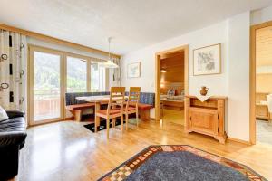 a living room with a table and a dining room at Haus Tuklar in Brand