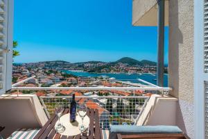 a balcony with a table and a view of a city at Fortuna apartment in Dubrovnik