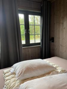 A bed or beds in a room at Jotunheimen Husky Lodge