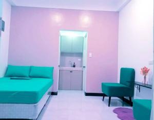 a living room with a couch and a chair at Lee Residences by JAL in Legazpi