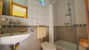 a bathroom with a sink and a toilet and a shower at Holiday home in Szantod - Balaton 20218 in Szántód +31 photos
