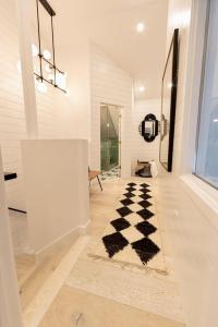 a hallway with a black and white checkered rug at Palace de Pow in Alta