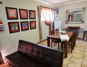 a living room with a couch and a dining room table at Huis Afrika in Vanderbijlpark