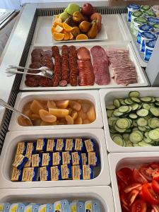 a refrigerator filled with lots of different types of food at Silver Major in Kaba