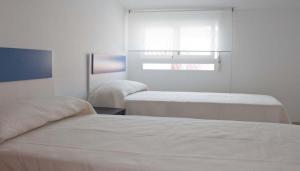 Postel nebo postele na pokoji v ubytování Apartamentos Boutique Benicasim + 15 fotografií