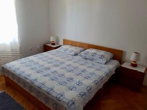 a bedroom with a bed and two night stands at Apartmani Luka in Korčula