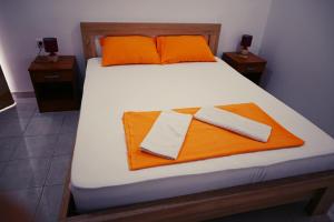 a bed with orange and white towels on it at Top Jaz Apartments in Budva