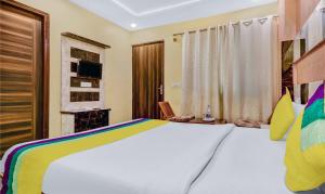 a bedroom with a large bed and a television at Itsy By Treebo - Royal Residency in Chandīgarh