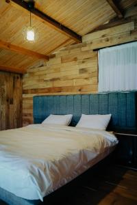 a bed in a room with wooden walls at Kartepe LOFT in Kartepe