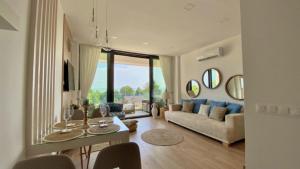 a living room with a couch and a table at Lakeview Apartman in Alsóörs