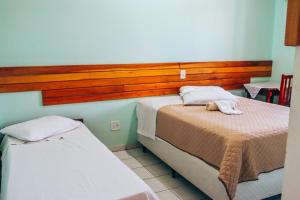 Postel nebo postele na pokoji v ubytování Hotel Pato Branco