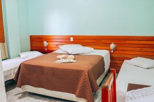 Postel nebo postele na pokoji v ubytování Hotel Pato Branco