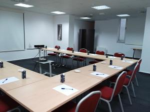 a conference room with wooden tables and chairs at B&B HOTEL Madrid Pinar de las Rozas in Las Rozas de Madrid