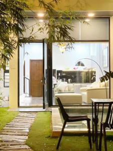 a living room with a couch and a chair at Tehya pool house 3 Bedrooms- My Khe Beach in Da Nang