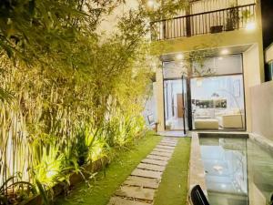 a house with a swimming pool and a garden at Tehya pool house 3 Bedrooms- My Khe Beach in Da Nang