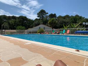 a large swimming pool with aitamin at « La Palmeraie » Villa résidentielle avec piscine in La Palmyre