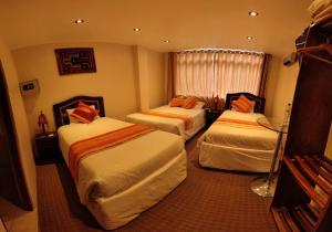 a hotel room with two beds and a window at Andino in Machu Picchu