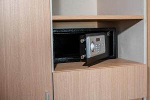 a microwave oven in a cabinet in a room at Gran Hotel Dakar in Mendoza