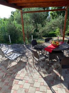 a patio with a table and chairs on a patio at Bungalow Maslina in Podstrana
