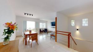 a living room with a table and a dining room at Villa Reymar - diseño y vistas al mar in Tossa de Mar