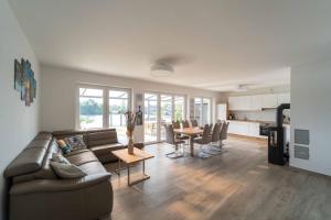 ein Wohnzimmer mit Sofa und Tisch in der Unterkunft Seevilla am See mit Sauna, Kamin, privatem Steg und Seezugang in Barßel