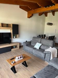 a living room with a couch and a table at El Mirador de Gredos 3 in Navaluenga