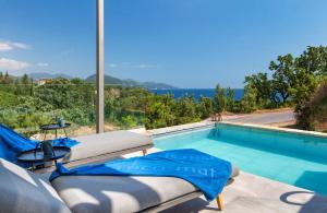 a villa with a swimming pool with a view at Ilvy Suites Sivota in Sivota