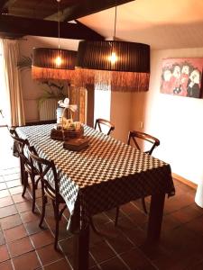 a dining room table with chairs and a checkered table cloth at De Beijersche Stee , Landhuysje in Stolwijk