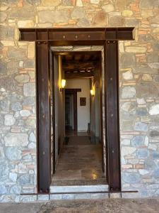 a hallway of a stone building with a wooden doorway at Casa al Maestro B&B in Radicofani
