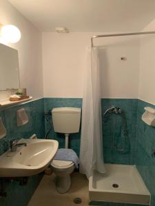 a bathroom with a toilet and a sink and a shower at Philoxeni Akti in Kanali