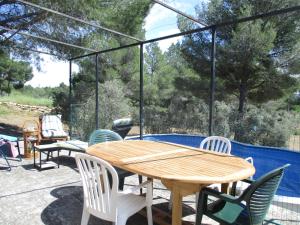 a wooden table and chairs on a patio at Mazet pleine nature in Mouriès