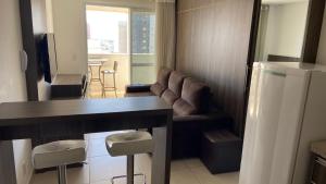 a living room with a couch and a table at Flat Brookfield Towers 2414 in Goiânia