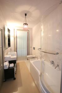 a bathroom with a tub and a toilet and a sink at A Casa di Maria in Grinzane Cavour