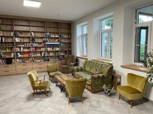 a living room with a couch and chairs and a table at Stanica Rowerowa Wygnanki in Wygnanki