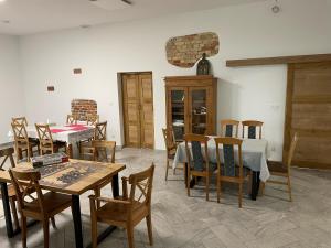 a dining room with wooden tables and chairs at Stanica Rowerowa Wygnanki in Wygnanki